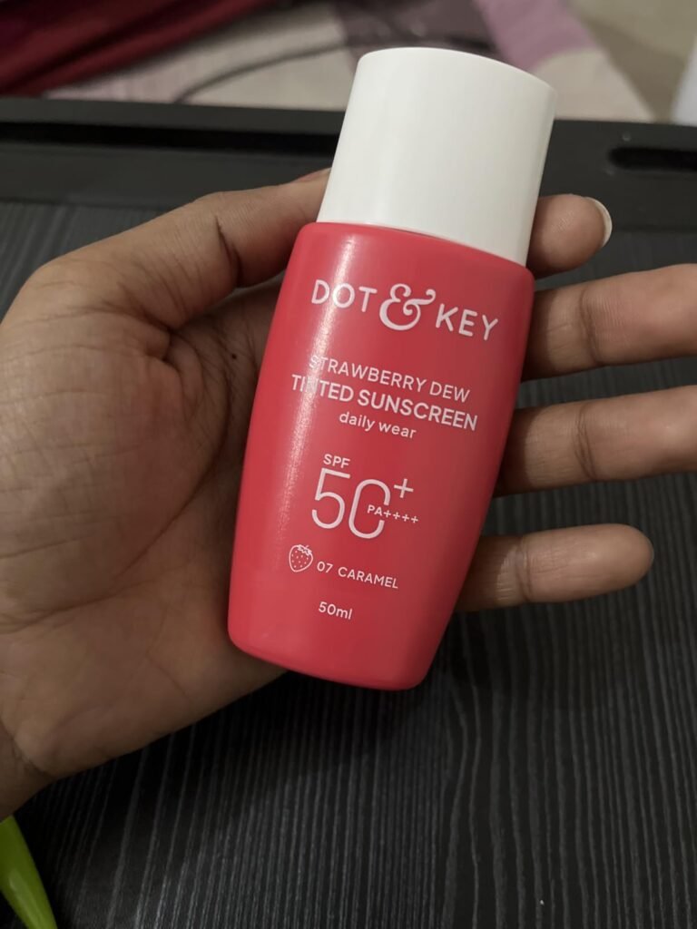 Hand holding Dot & Key Strawberry Dew Tinted Sunscreen SPF 50+ PA++++ 50ml shade 07 Caramel for daily sun protection review